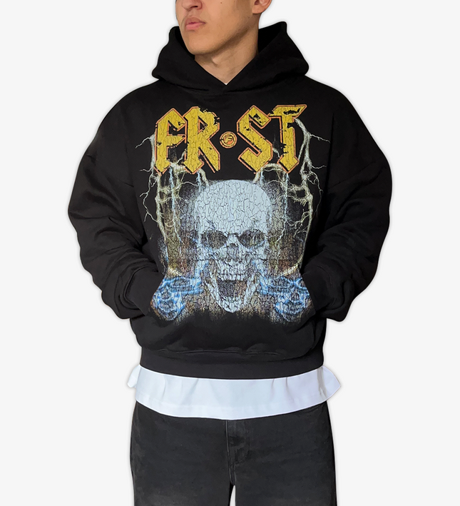 Black oversized boxy fit pullover hoodie named 'Rockstar Hoodie' featuring a vintage-inspired AC/DC-style graphic print on the front. Made from 100% cotton, 500GSM heavyweight fabric, designed to replicate classic band tee aesthetics