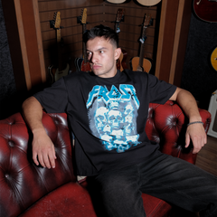 Black oversized boxy fit t-shirt named 'Graveyard Tee' featuring a vintage-inspired Metallica-style graphic print on the front. Made from 100% cotton, 300GSM heavyweight fabric, designed to replicate classic band tee aesthetics